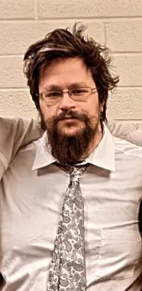 Jeff in a dress shirt and patterned tie